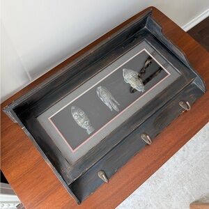 decorative art piece and a functional rack for keys or other small items.